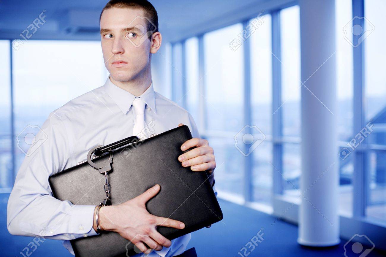 26195681-businessman-with-a-briefcase-handcuffed-to-his-wrist.jpg